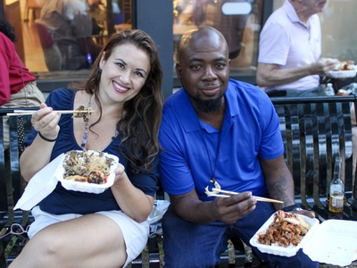 Two people enjoy food at the Delaware Korean Festival