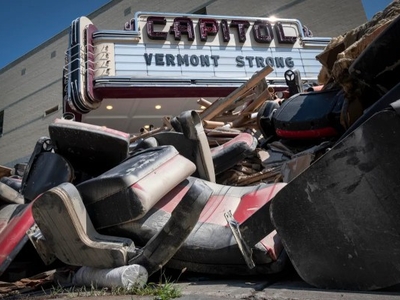 a pile of chairs in front of a building.
