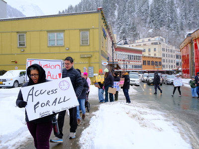 Demonstrators march through Downtown Juneau to rally at the Alaska State Capitol with the Key Coalition, advocating for disability rights and increased services on Mar. 18, 2026. (Photo by Corinne Smith/Alaska Beacon)