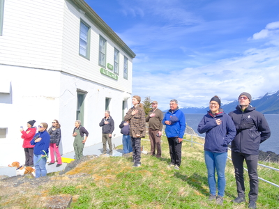 A group of supporters say the pledge of allegiance during the opening ceremony and flag raising for Eldred Rock Lighthouse on May 30, 2026. (Photo by Corinne Smith/Alaska Beacon)
