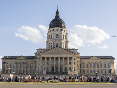 A crowd passes Friday in front of the Kansas Statehouse as part of the National March for Queer and Trans Youth Autonomy