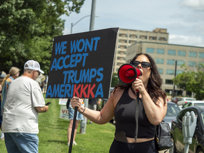 A woman who would only identify herself as Kali shouts, "Who's got the power? We got the power," at the June 14, 2025, "No Kings" rally in Topeka