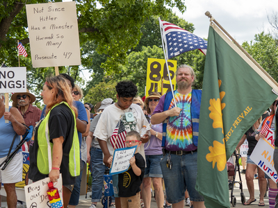 Alan Schmidt, of Hoyt, appears at the June 14, 2025, "No Kings" rally in Topeka wearing a tie-dyed shirt and holding an upside-down American flag