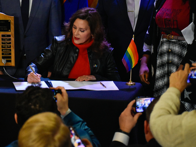 Whitmer signs LGBTQ+ non-discrimination bill into law alongside civil rights pioneer Mel Larsen