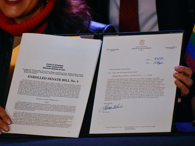 Whitmer signs LGBTQ+ non-discrimination bill into law alongside civil rights pioneer Mel Larsen