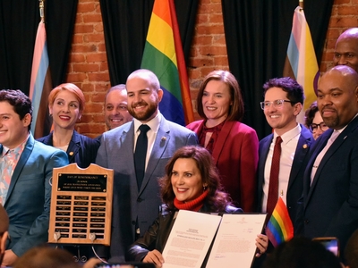 Whitmer signs LGBTQ+ non-discrimination bill into law alongside civil rights pioneer Mel Larsen