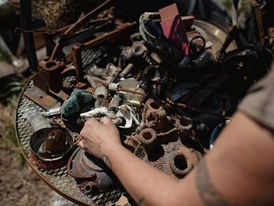 Tyler White digs through items she kept after the Hermits Peak Calf Canyon fire.