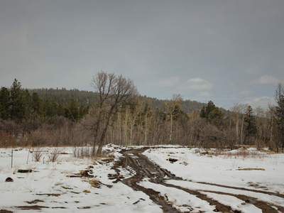 Mud and snow impede the driveway to David Martinez’s property