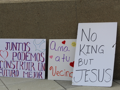 Signs at a rally for Haitians in Springfield, Ohio on June 25, 2026. (Photo by Megan Henry, Ohio Capital Journal).