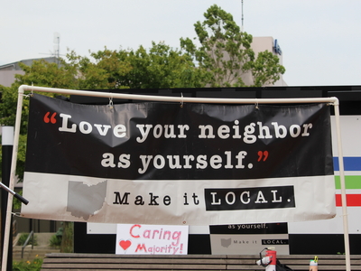 A sign at a rally for Haitians in Springfield, Ohio on June 25, 2026. (Photo by Megan Henry, Ohio Capital Journal).