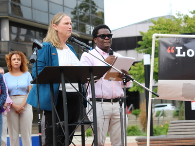 Katie Kersh (left) and Biassu Pierre (right) speak at a rally for Haitians in Springfield, Ohio on June 25, 2026. Both of them are with Advocates for Basic Legal Equality in Dayton. (Photo by Megan Henry, Ohio Capital Journal).