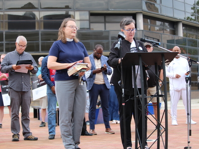 Rev. Michelle Boomguard with Christ Episcopal Church in Springfield (left) and Rev. Dr. Marian Stewart with Springfield Neighbors United (right) speak at a rally for Haitians in Springfield, Ohio on June 25, 2026. (Photo by Megan Henry, Ohio Capital Journal).