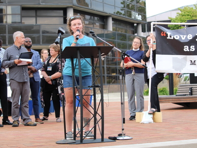 Jen Casto, with Indivisible Springfield, speaks at a rally for Haitians in Springfield, Ohio on June 25, 2026. (Photo by Megan Henry, Ohio Capital Journal).
