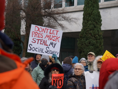 Many seniors were among the crowd that showed up at Oregon Sen. Ron Wyden's office in northeast Portland on Wednesday, July 5, 2025 to protest recent actions by the Trump administration. (Photo by Alex Baumhardt/Oregon Capital Chronicle)