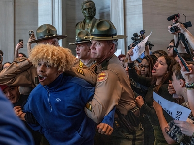 Tennessee Highway Patrol officers subdue a Nashville high school student during a gun safety protest at the Capitol on Thursday. The student had attempted to follow lawmakers into a bathroom. (Photo: John Partipilo)
