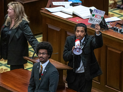 Reps. Justin Jones, right, Justin Pearson, bottom, and Gloria Johnson, left, bring a megaphone onto the Tennessee House floor on March 30, 2023. (Photo: John Partipilo)