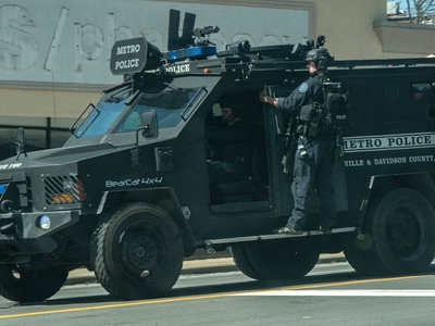 A police vehicle rolls down Nashville's Hillsboro Road towards Covenant School on Monday. (Photo: John Partipilo)
