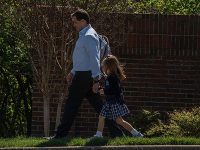 A father picks his daughter up from St. Paul Christian School, a private elementary school about a quarter of a mile from Covenant Church. (Photo: John Partipilo)