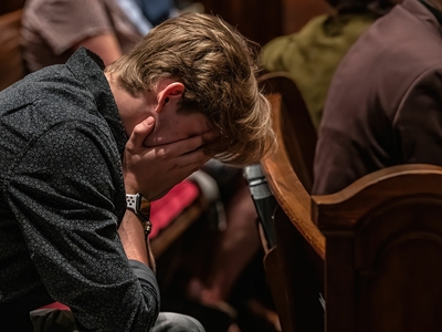 A mourner prays during a March 27, 2023 community vigil service at Belmont United Methodist Church. (Photo: John Partipilo)
