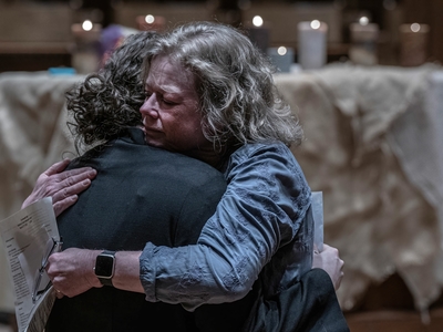 Kim Hawkins, right, hugs her daughter, Keller, at Monday's Belmont United Methodist Church vigil. (Photo: John Partipilo)