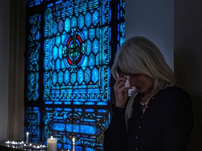 Russanne Buchi-Fotre weeps after lighting a candle for victims at a community vigil at Belmont United Methodist Church in Nashville. (Photo: John Partipilo)