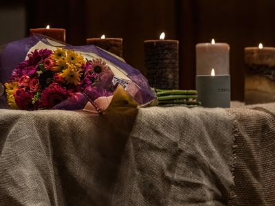 Seven candles burn on the altar at Belmont United Methodist Church, one for each of the shooting victims and one for the shooter. (Photo: John Partipilo)