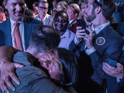 O'Connell hugs Councilmember Terry Vo, while former council member Bob Mendes looks on. (Photo: John Partipilo)