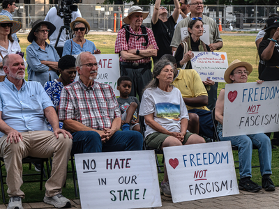 Attendees at a memorial in honor of two late civil rights icons hold signs in response to recent neo-Nazi activity in Nashville. (Photo: John Partipilo)