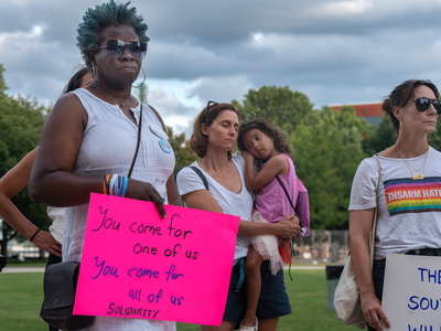 Shaundelle Brooks, a Democratic candidate for the State House of Representatives in Nashville's District 60, holds a sign at the vigil. (Photo: John Partipilo)