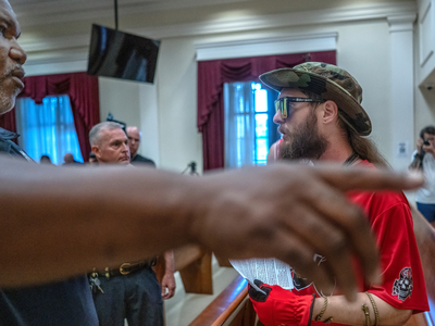 "Get out." A Metro Nashville Police officer orders a member of a neo-Nazi group to leave Metro Council chambers on Tuesday night after the group disrupted the meeting. (Photo: John Partipilo)