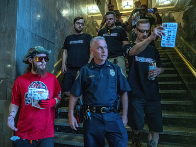 A Metro Nashville Police officer leads member Goyim Defense League out of the courthouse after Metro Council President Pro-tem Zulfat Suara cleared the spectator gallery. (Photo: John Partipilo)