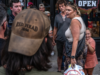 A child cowers behind her mother, who confronted members of a Neo-Nazi hate group. (Photo: John Partipilo)
