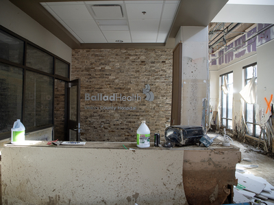 The front lobby of Unicoi County Hospital in Erwin, Tennessee, is covered in debris, mud, and mold after a flash flood during Hurricane Helene destroyed the building, which opened in 2018. (Maddy Alewine for KFF Health News)
