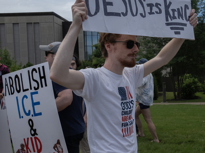 A man carrying a gun was one of few counter-protesters seen at Nashville's "No Kings" rally. (Photo: John Partipilo/Tennessee Lookout)