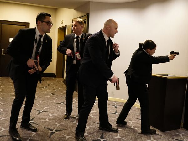Federal agents draw their guns out after an incident at the annual White House Correspondents Association Dinner April 25, 2026 in Washington, DC. According to reports, President Donald Trump, along with other government officials, were evacuated from the Washington Hilton after what sounded like gun fire. (Photo by Nathan Howard/Getty Images)