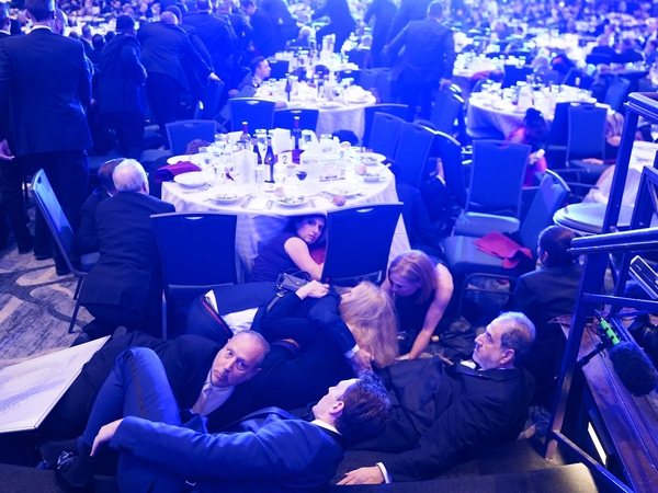 CEO of Strauss Media Richard Strauss, U.S. Rep. Jamie Raskin, D-Md., Kerry Kennedy, daughter of U.S. Health and Human Services Secretary Robert F. Kennedy Jr., Boston Globe DC Bureau Chief Jackie Kucinich,and D.C. Shadow Sen. Paul Strauss hide under tables after an incident at the annual White House Correspondents Association Dinner April 25, 2026 in Washington, D.C. (Photo by Nathan Howard/Getty Images)