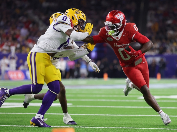 Amare Thomas #0 of the Houston Cougars gives a stiff arm to Tamarcus Cooley #0 of the Louisiana State Tigers in the second half during the Kinder's Texas Bowl at NRG Stadium on Dec. 27, 2025 in Houston, Texas. (Photo by Tim Warner/Getty Images)
