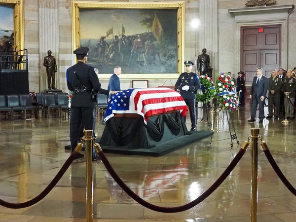 Family, staff and current and former lawmakers, including former House Speaker Kevin McCarthy, in background, filed past the flag-draped casket of the late Sen. Lindsey Graham, R-S.C., at the congressional tribute in the U.S. Capitol Rotunda on Tuesday, July 28, 2026. (Photo by Ashley Murray/States Newsroom)