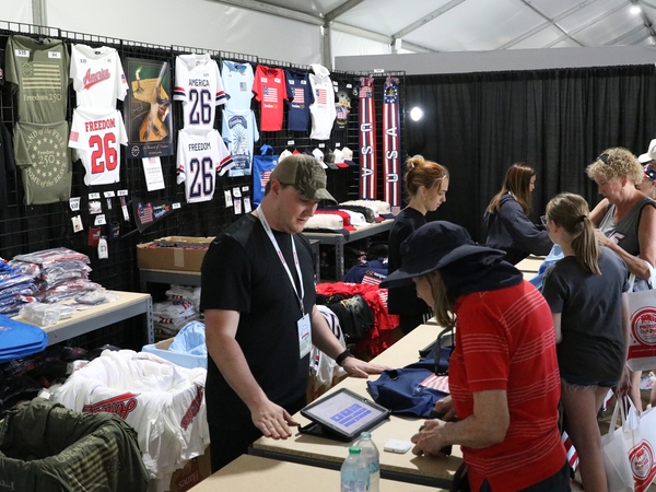 Merchandise tied to America’s 250th birthday is sold in a stall at Freedom 250’s Great American State Fair in Washington, D.C., on June 30, 2026. (Photo by Sam Gauntt/States Newsroom)
