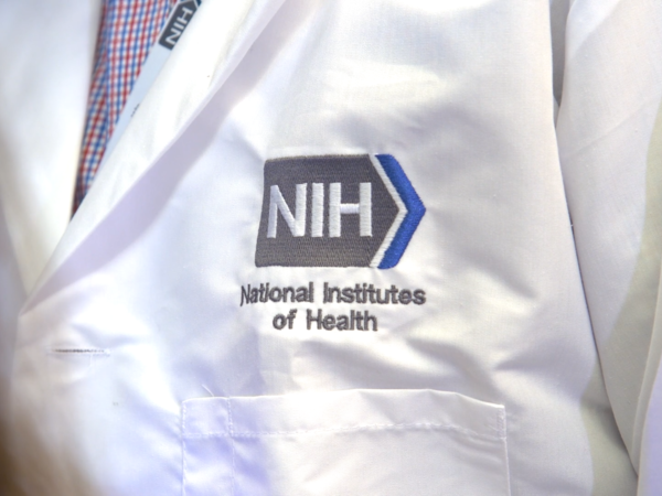 Democrats in Congress are raising questions about a draft rule proposed by the Trump administration that would change the way grants, such as those by the National Institutes of Health, are administered. Shown is an NIH Pediatric Oncology Branch researcher's lab jacket, embroidered with the NIH logo. (Photo courtesy NIH)