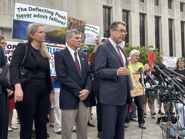 Norm Eisen, an attorney with the Democracy Defenders Fund, speaks outside District of Columbia Superior Court after an arraignment hearing for David C. Hearn, center, on felony charges of destruction of property of $1,000 or more. At left is Mary C. Dohrmann, senior counsel at the Washington Litigation Group and another member of Hearn’s legal team. (Photo by Jennifer Shutt/States Newsroom)