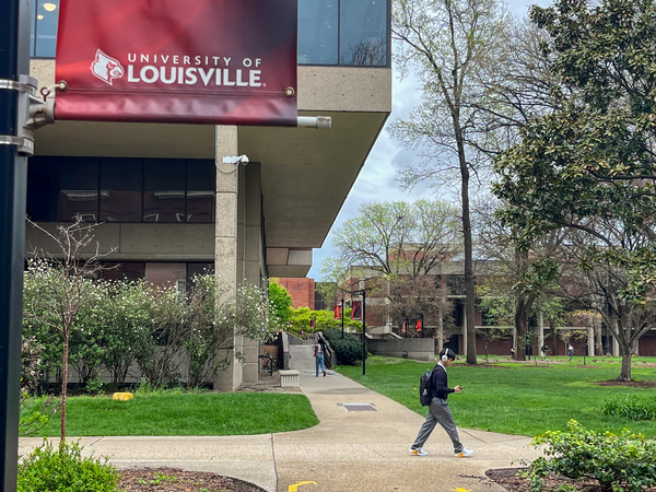 Students walk across the University of Louisville campus.
