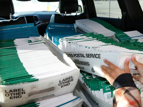 A Utah County election worker picks up mailed ballots from the United States Postal Service office on Oct. 26, 2020 in Provo, Utah. (Photo by George Frey/Getty Images)
