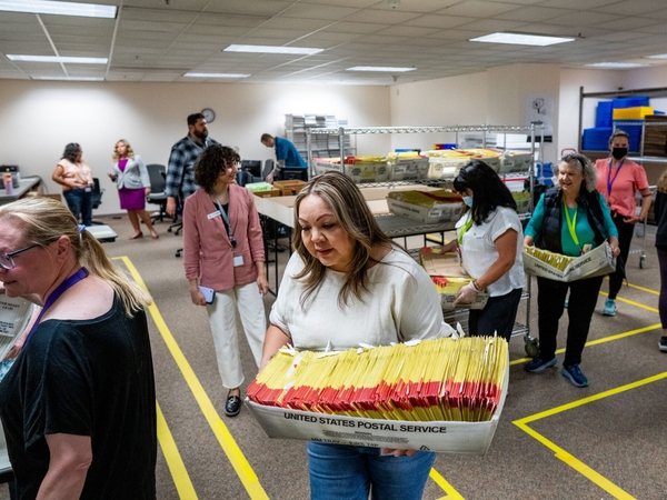 Election worker Davina Trejo carries a box of ballots to her work station at the Salt Lake County Government Center in Salt Lake City as votes are cast in Utah’s primary election on June 25, 2024. (Photo by Spenser Heaps for Utah News Dispatch
