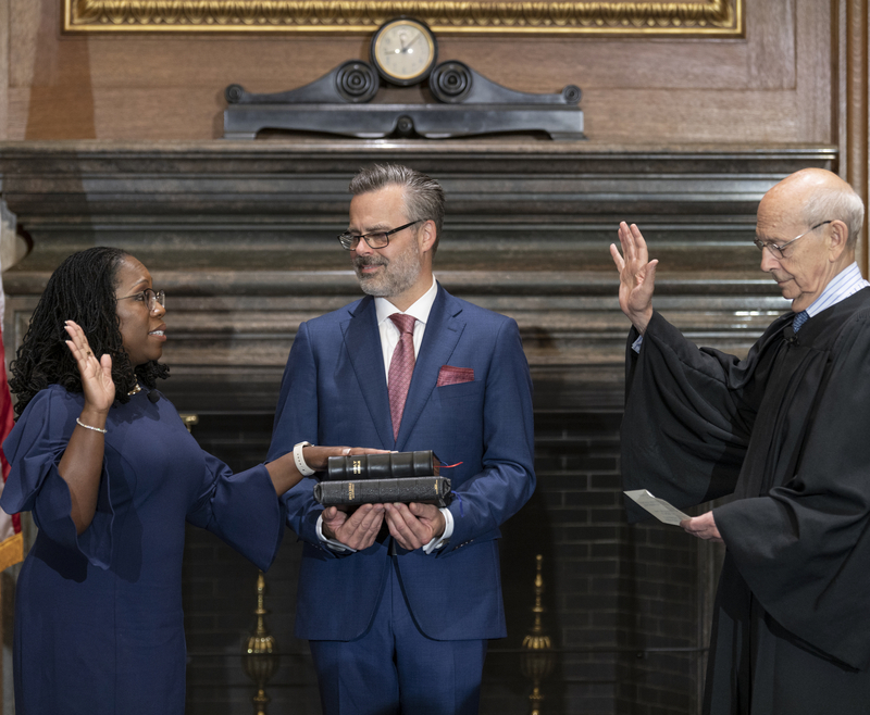 Justice Stephen G. Breyer (Retired) administers the Judicial Oath to Judge Ketanji Brown Jackson in the West Conference Room, Supreme Court Building. Dr. Patrick Jackson holds the Bible. Credit: Fred Schilling, Collection of the Supreme Court of the United States.
