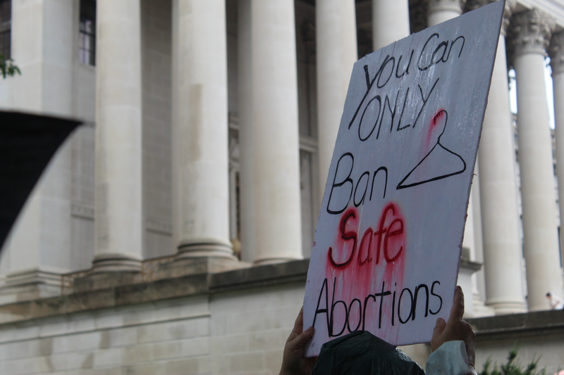 A person holds a sign on July 9, at a rally in Charleston for abortion rights. Photo by Ian Karbal