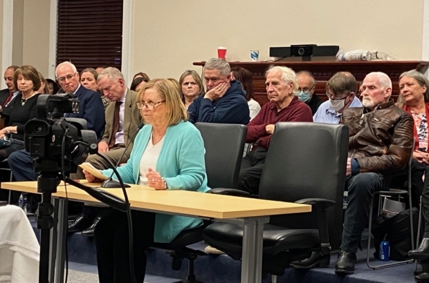 Patti Amirault testifies at a packed Governor's Council hearing about the pardon of her husband Gerald Amirault and his sister Cheryl Amirault Lefave on Dec. 13, 2022. (Photo by Shira Schoenberg)