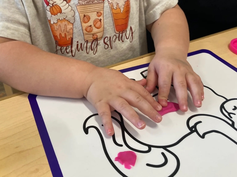 Holland Cole, 3, molds Play-Doh at Cubby's Child Care Center in Bridgeport. Photo by Dan Lawton