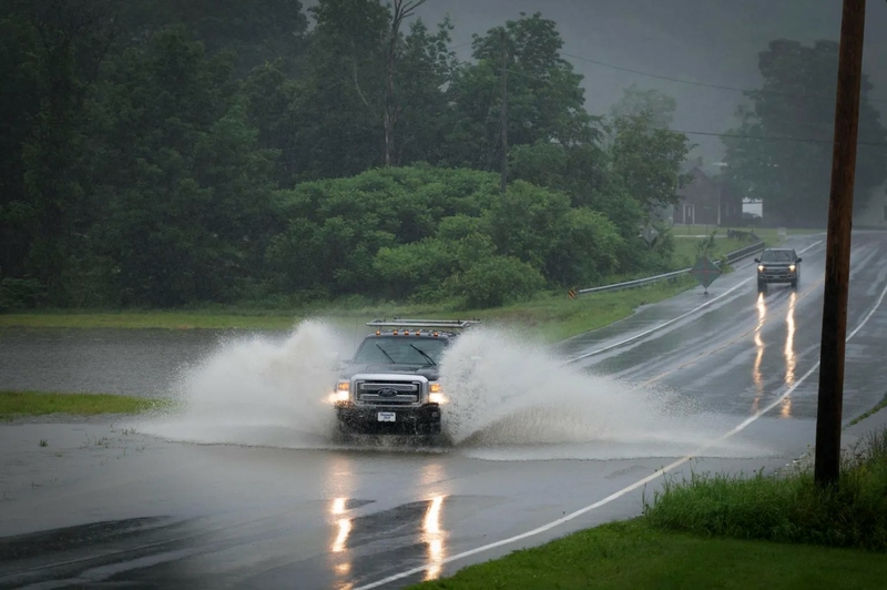 Drivers cross water flowing across Route 100 between Hancock and Rochester on Monday, July 10, 2023. Photo by Glenn Russell/VTDigger