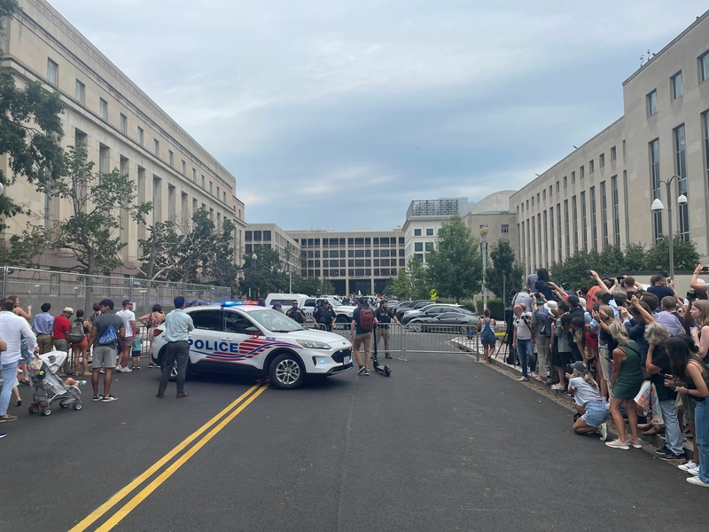 People strain to see former President Donald Trump as he arrives at the federal courthouse in Washington, D.C., on Aug. 3, 2023. (Ariana Figueroa/States Newsroom)